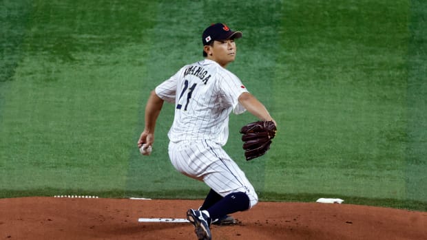 Mar 21, 2023; Miami, Florida, USA; Japan starting pitcher Shota Imanaga (21) pitches against the USA in the first inning at LoanDepot Park.