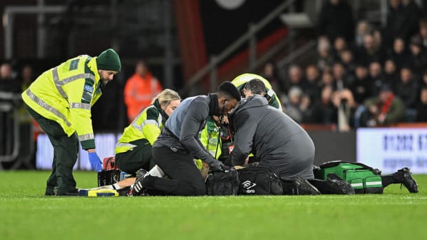 Medical staff pictured treating Tom Lockyer on the field at Bournemouth's Vitality Stadium after the Luton Town captain collapsed during a Premier League game in December 2023