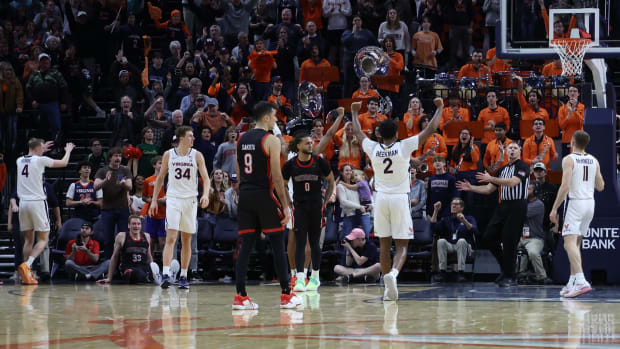  Virginia Cavaliers players celebrate in the final second against the Northeastern Huskies in the second half at John Paul Jones Arena.