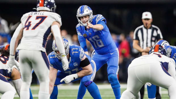 Detroit Lions quarterback Jared Goff (16) talks to center Frank Ragnow (77) before a snap against the Denver Broncos during the second half at Ford Field in Detroit on Saturday, Dec. 16, 2023.  