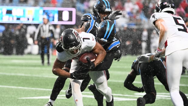 Atlanta Falcons running back Bijan Robinson (7) is tackled by Carolina Panthers safety Jeremy Chinn (21) in the second quarter at Bank of America Stadium.