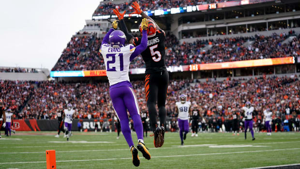 Cincinnati Bengals wide receiver Tee Higgins (5) catches a touchdown pass as Minnesota Vikings cornerback Akayleb Evans (21) defends in the fourth quarter of a Week 15 NFL football game between the Minnesota Vikings and the Cincinnati Bengals, Saturday, Dec. 16, 2023, at Paycor Stadium in Cincinnati. The Cincinnati Bengals won 27-24 in overtime.