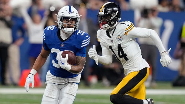 Colts safety Julian Blackmon (32) runs after intercepting a pass intended for Steelers wide receiver George Pickens (14).