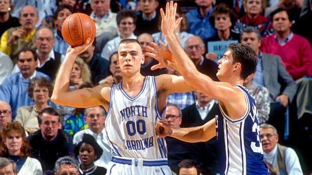 North Carolina Tar Heels center Eric Montross (00) looks to pass as Duke Blue Devils center Christian Laettner (32) defends in the Tar Heels 75-73 victory against the Blue Devils at the Dean E. Smith Center. Montross is playing with a cut below his left eye.