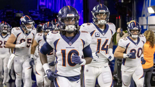 Denver Broncos wide receiver Jerry Jeudy (10) leads his team out for warm ups before the game against the Detroit Lions at Ford Field.
