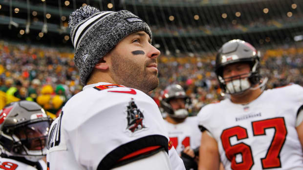 Baker Mayfield looks up wearing a winter hat