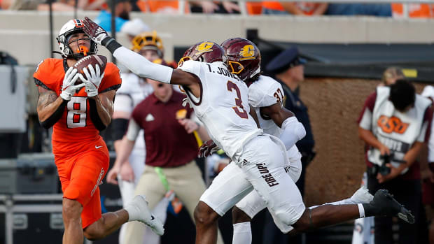 OSU's Braydon Johnson (8) catches a pass as Central Michigan's Trey Jones (3)  defend in the first quarter.