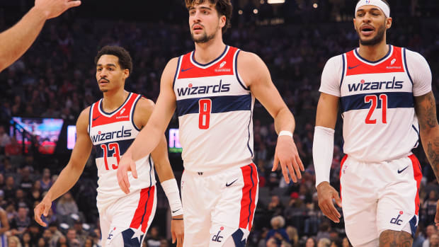 Washington Wizards guard Jordan Poole (13) and forward Deni Avdija (8) and center Daniel Gafford (21) during a time out called against the Sacramento Kings during the first quarter at Golden 1 Center.