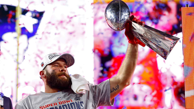 Patriots wide receiver Julian Edelman (11) celebrates with the Vince Lombardi trophy after defeating the Seahawks in Super Bowl XLIX at University of Phoenix Stadium.