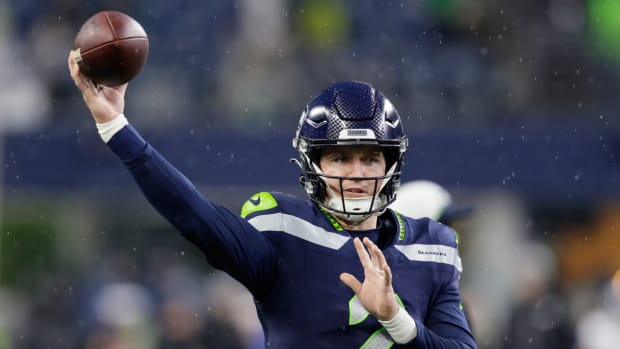 Seahawks quarterback Drew Lock throws a pass during a game.