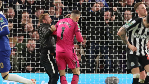 A Chelsea fan pictured barging into Newcastle United goalkeeper Martin Dubravka moments after Mykhailo Mudryk had scored a late equalizer in an EFL Cup quarter-final at Stamford Bridge in December 2023