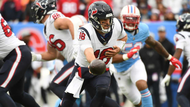 Texans quarterback Case Keenum hands the ball off during a game against the Titans.