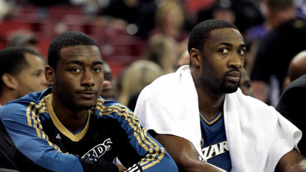 December 8, 2010; Sacramento, CA, USA; Washington Wizards guard John Wall (left) sits on the bench next to guard Gilbert Arenas (right) against the Sacramento Kings in the first quarter at Arco Arena. Mandatory Credit: Cary Edmondson-USA TODAY Sports