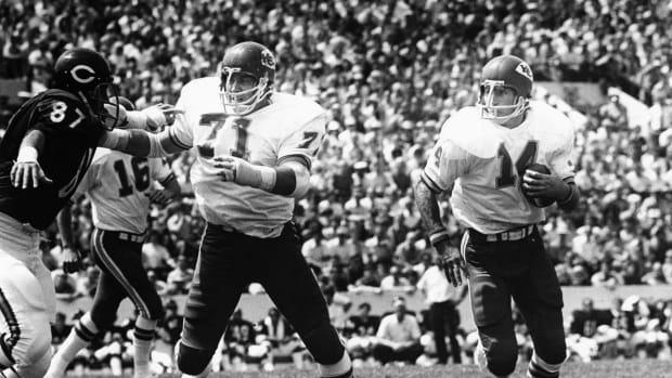 Aug 5, 1972; Chicago, IL, USA; FILE PHOTO; Kansas City Chiefs left guard Ed Budde (71) blocks for running back Ed Podolak (14) as he carries the ball against Chicago Bears defensive end Steve DeLong (87) at Soldier Field during the 1972 preseason. Mandatory Credit: Rod Hanna-USA TODAY Sports  
