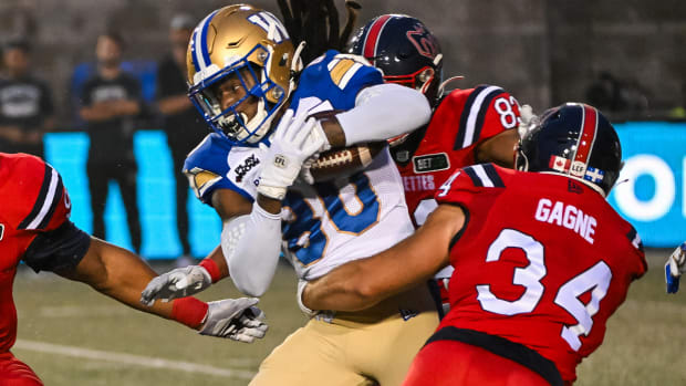 Jul 1, 2023; Montreal, Quebec, CAN; Winnipeg Blue Bombers wide receiver Janarion Grant (80) gets tackled by Montreal Alouettes fullback Alexandre Gagne (34) during the first quarter at Percival Molson Memorial Stadium. Mandatory Credit: David Kirouac-USA TODAY Sports  