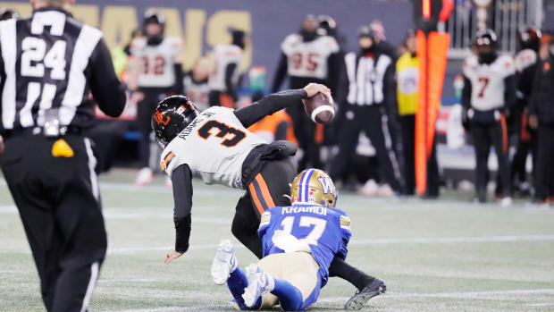 Nov 11, 2023; Winnipeg, Manitoba, CAN; BC Lions quarterback Vernon Adams Jr. (3) is tackled from behind by Winnipeg Blue Bombers defensive back Redha Kramdi (17) during the second half of the game at IG Field. Winnipeg wins 24-13 to advance to 2023 Grey Cup. Mandatory Credit: Bruce Fedyck-USA TODAY Sports.  