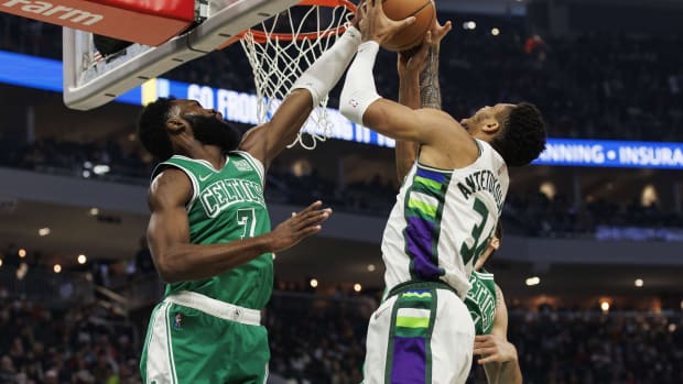 Boston Celtics guard Jaylen Brown (7) blocks the shot of Milwaukee Bucks forward Giannis Antetokounmpo (34) 