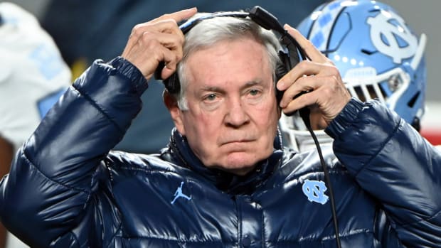 UNC coach Mack Brown adjusts his headset during a game.