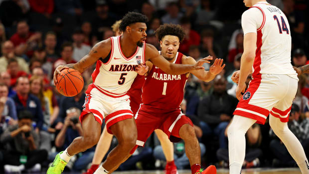 Dec 20, 2023; Phoenix, Arizona, USA; Arizona Wildcats guard KJ Lewis (5) handles the ball against Alabama Crimson Tide guard Mark Sears (1) during the first half in the Hall of Fame Series at Footprint Center.