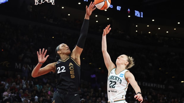 Aces forward A’ja Wilson blocks a shot by the Liberty’s Courtney Vandersloot #22 in the 2023 WNBA Finals.