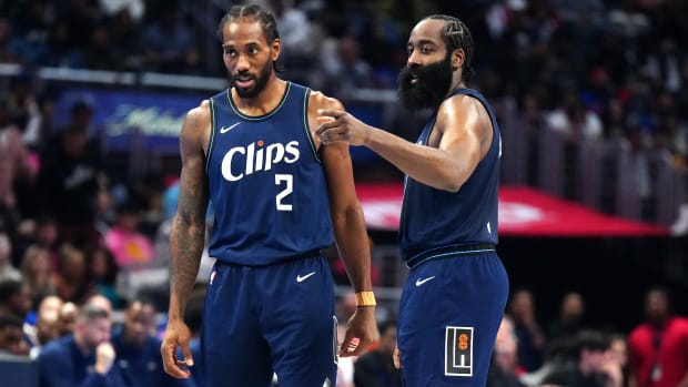 Clippers forward Kawhi Leonard and guard James Harden talk on the court during their game against the Pelicans.