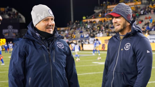Nov 19, 2023; Hamilton, Ontario, CAN; Montreal Alouettes head coach Head Coach Jason Maas (right) and assistant coach Anthony Calvillo (left) during warm up of the 110th Grey Cup against the Winnipeg Blue Bombers at Tim Hortons Field. Mandatory Credit: John E. Sokolowski-USA TODAY Sports  