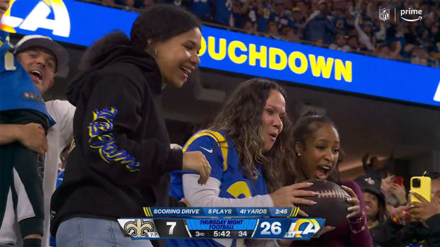 Kyren Williams’ mom, Taryn, catches the football after her son scored a touchdown.