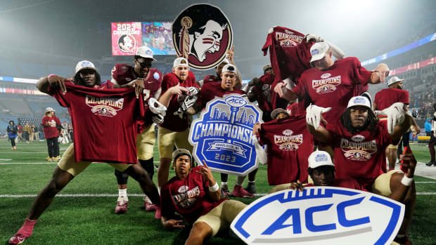 Florida State football players pose in celebration after winning the ACC championship.
