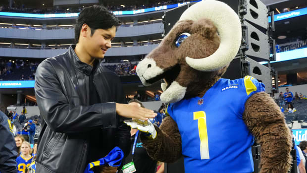 Dec 21, 2023; Inglewood, California, USA; Los Angeles Dodgers player Shohei Ohtani (left) shakes hands with Los Angeles Rams mascot Rampage at SoFi Stadium.