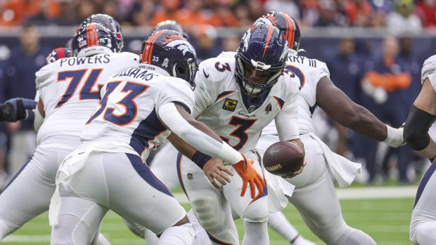 Denver Broncos quarterback Russell Wilson (3) fakes a handoff to running back Javonte Williams (33) on a play during the first quarter against the Houston Texans at NRG Stadium.