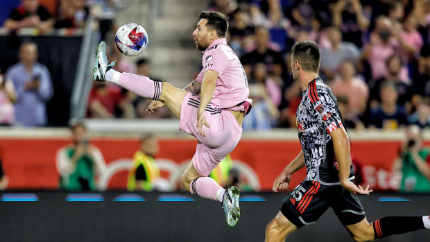 Inter Miami forward Lionel Messi kicks at the ball in the air with his left foot.