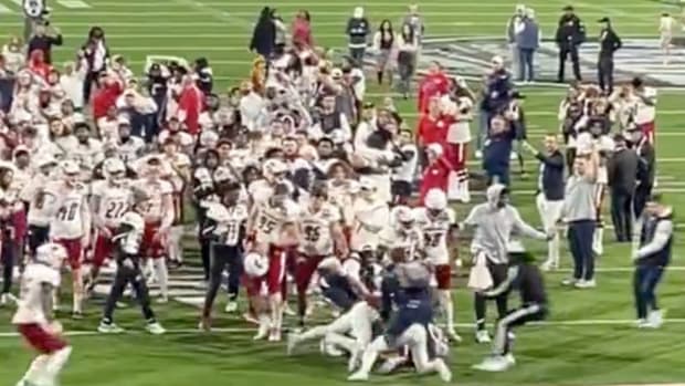 South Alabama and Eastern Michigan football teams fight on the field after the 68 Ventures Bowl.