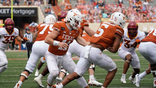 Nov 27, 2020; Austin, Texas, USA; Texas Longhorns quarterback Sam Ehlinger (11) hands the ball off to running back Bijan Robinson (5) in the first quarter against the Iowa State Cyclones at Darrell K Royal-Texas Memorial Stadium. Mandatory Credit: Scott Wachter-USA TODAY Sports