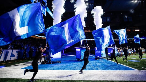The Detroit Lions cheer squad takes the field before a game against Denver Broncos.