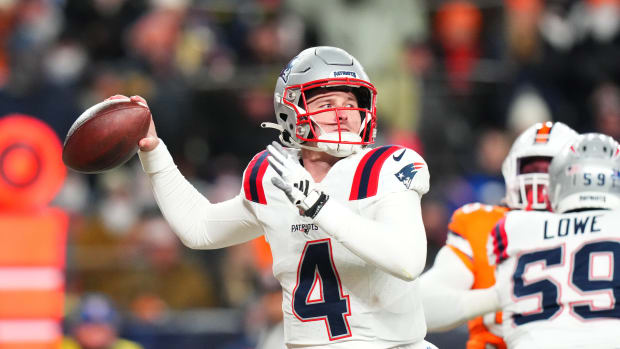 New England Patriots quarterback Bailey Zappe (4) prepares to pass in the first quarter against the Denver Broncos at Empower Field at Mile High.