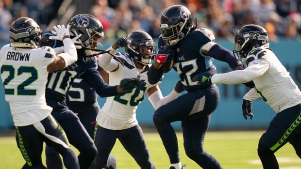Tennessee Titans running back Derrick Henry (22) breaks free for extra yards against the Seattle Seahawks defense during their game at Nissan Stadium in Nashville, Tenn., Sunday, Dec. 24, 2023.