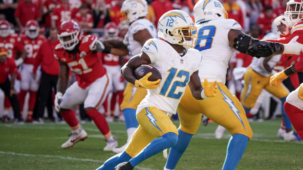 Oct 12, 2023; Kansas City, Missouri, USA; Los Angeles Chargers wide receiver Derius Davis (12) runs the ball against the Kansas City Chiefs during the game at GEHA Field at Arrowhead Stadium. Mandatory Credit: Denny Medley-USA TODAY Sports  