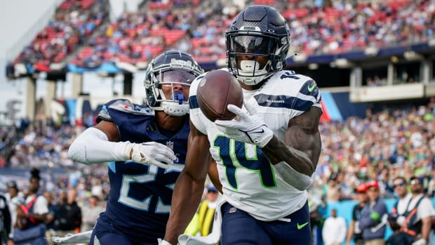 Seattle Seahawks wide receiver DK Metcalf (14) pulls in a touchdown past Tennessee Titans cornerback Tre Avery (23) during the fourth quarter at Nissan Stadium in Nashville, Tenn., Sunday, Dec. 24, 2023.