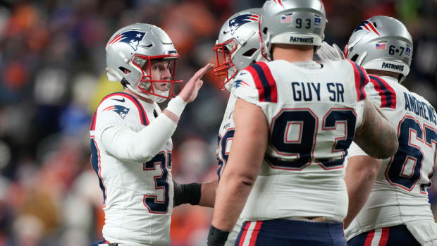 New England Patriots place-kicker Chad Ryland, left, is greeted by teammates after kicking a field goal during the first half of an NFL football game against the Denver Broncos, Sunday, Dec. 24, 2023, in Denver. (AP Photo/David Zalubowski)   