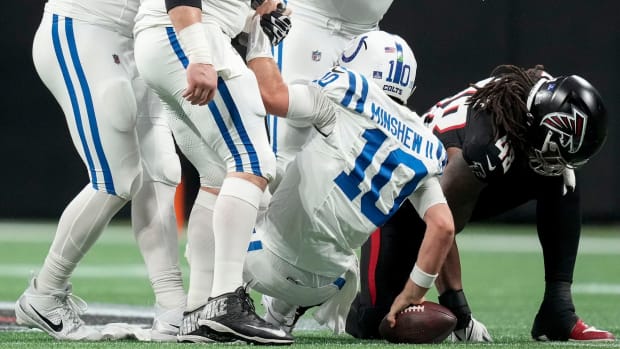 Indianapolis Colts quarterback Gardner Minshew II (10) is helped up from the turf after a sack by Sunday, Dec. 24, 2023, during a game against the Atlanta Falcons at Mercedes-Benz Stadium in Atlanta.