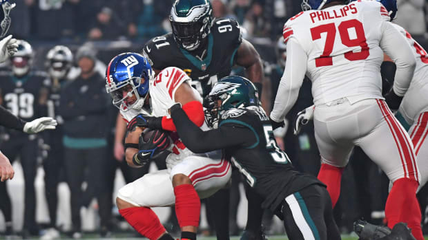 Dec 25, 2023; Philadelphia, Pennsylvania, USA; New York Giants running back Saquon Barkley (26) is tackled by Philadelphia Eagles linebacker Shaquille Leonard (53) during the first quarter at Lincoln Financial Field.