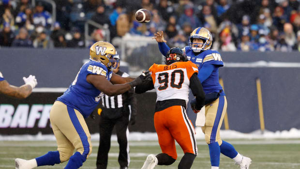 Nov 13, 2022; Winnigeg, Manitoba, CAN; BC Lions defensive lineman Mathieu Betts (90) tries to block a pass by Winnipeg Blue Bombers quarterback Zach Collaros (8) in the first half at Investors Group Field. Mandatory Credit: James Carey Lauder-USA TODAY Sports  
