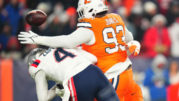 Denver Broncos defensive tackle D.J. Jones (93) sacks New England Patriots quarterback Bailey Zappe (4) in the first quarter at Empower Field at Mile High.