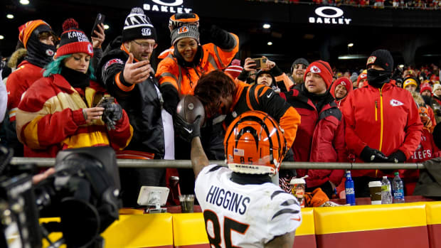 Cincinnati Bengals wide receiver Tee Higgins (85) hands his mother, Lady Stewart, a football after scoring a touchdown in the third quarter during the AFC championship NFL game between the Cincinnati Bengals and the Kansas City Chiefs, Sunday, Jan. 29, 2023, at GEHA Field at Arrowhead Stadium in Kansas City, Mo. The Kansas City Chiefs won, 23-20. Cincinnati Bengals At Kansas City Chiefs Afc Championship Jan 29 0386  
