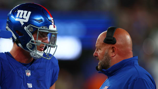 Aug 26, 2023; East Rutherford, New Jersey, USA; New York Giants head coach Brian Daboll speaks with quarterback Tommy DeVito (5) during the second half of their game against the New York Jets at MetLife Stadium.