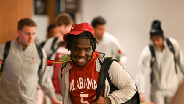 Running back Roydell Williams holds a rose in his mouth as the Crimson Tide checks in at the Rose Bowl