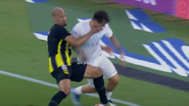Al-Ittihad midfielder Fabinho pictured (left) striking Al Nassr's Otavio in the face with his right hand during a Saudi Pro League game in December 2023 - Fabinho was sent off following a VAR review