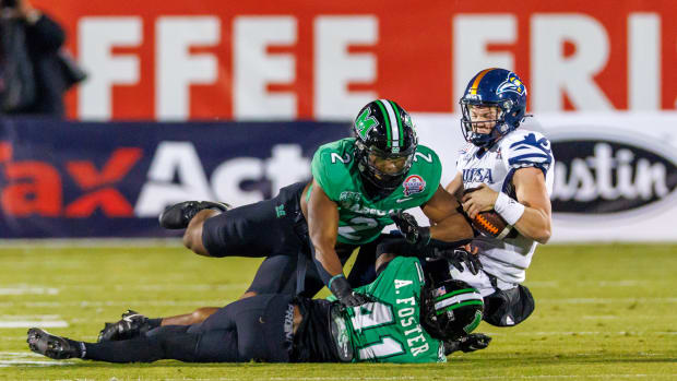 Dec 19, 2023; Frisco, TX, USA; UTSA Roadrunners quarterback Owen McCown (13) is tackled by Marshall Thundering Herd defensive lineman Elijah Alston (2) and cornerback Ahmere Foster (41) during the first quarter at Toyota Stadium. Mandatory Credit: Andrew Dieb-USA TODAY Sports