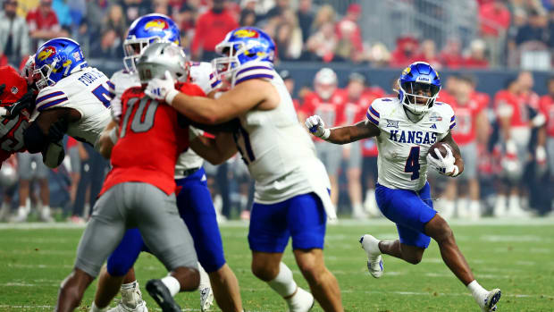 Dec 26, 2023; Phoenix, AZ, USA; Kansas Jayhawks running back Devin Neal (4) runs with the ball during the second half against the UNLV Rebels in the Guaranteed Rate Bowl at Chase Field.