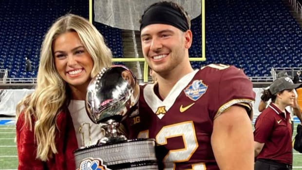 Katie Miller with Gophers quarterback Cole Kramer after Minnesota's 30-24 win over Bowling Green in the Quick Lane Bowl.